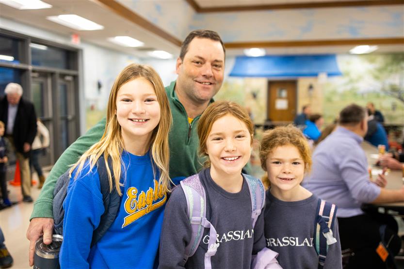 Students and their families enjoy donuts